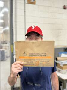 Dave holding the last folded bag of 100K